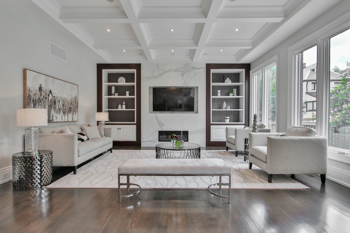 Bright living room with a marble fireplace wall and large windows